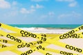 COVID-19 Quarantine Yellow Tape Strips Enclose Zone of the Ocean or Sea Sand Beach. 3d Rendering