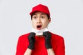 Covid-19, self-quarantine online shopping and delivery concept. Shocked and freak out asian courier in protective gloves