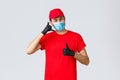 Covid-19, self-quarantine, online shopping and shipping concept. Friendly delivery guy in gloves and face mask, carrier