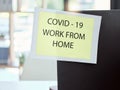 Covid, sign and work from home at the office for health and safety rules or regulations during pandemic. Label post of