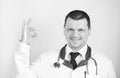 COVID-19 with smiling caucasian positive doctor with hope.Doctor makes a sign that everything is fine.Sign ok. Inspiring confidenc