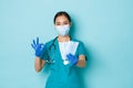 Covid-19, social distancing and coronavirus pandemic concept. Confident pretty asian female doctor, nurse recommend wear Royalty Free Stock Photo