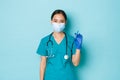 Covid-19, social distancing and coronavirus pandemic concept. Professional confident asian female doctor, nurse in Royalty Free Stock Photo