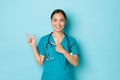 Covid-19, social distancing and coronavirus pandemic concept. Professional doctor, female nurse or physician in scrubs Royalty Free Stock Photo