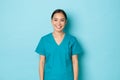 Covid-19, social distancing and coronavirus pandemic concept. Smiling attractive, cheerful asian nurse, medical worker Royalty Free Stock Photo