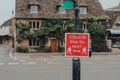 Covid-19 Stay 2 Metres Apart red sign on a street in Bourton-on-Water, Cotswolds, UK