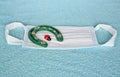 Covid-19, surgical mask, typical 3-ply to cover the mouth and nose with lucky charms ladybird and horseshoe