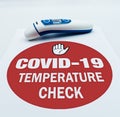 Covid-19 temperature check. Infrared digital thermometer. Coronavirus fever examination concept