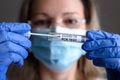 COVID-19 test in doctor hands close-up, woman in medical mask holds coronavirus swab collection kit