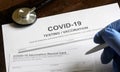 COVID-19 testing and vaccination forms on desk Royalty Free Stock Photo