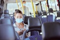 Covid, travel and phone social media with mask for illness prevention on public bus trip. Safety protocol girl face