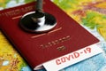 COVID 19 traveling document on world map background