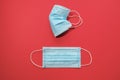 COVID-19 Two disposable surgical face masks on red background