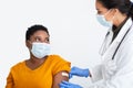 Doctor Sticking Plaster On Arm After Coronavirus Vaccination, White Background Royalty Free Stock Photo