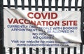 Covid-19 vaccination center sign attached to the entrance gates in London