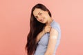 Vaccination. Portrait of young Caucasian woman posing on pink pastel background.