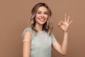 Covid-19 vaccination. Happy young girl showing arm with plaster after coronavirus vaccine injection. Royalty Free Stock Photo