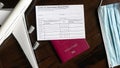 COVID-19 Vaccination Record Card on desk, coronavirus immunization certificate and tourist passport Royalty Free Stock Photo