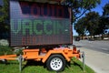 COVID Vaccine advertisement on a mobile traffic sign Royalty Free Stock Photo