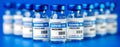 Covid-19 vaccine - coronavirus vaccination bottles. injection vials on blue background Royalty Free Stock Photo