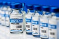 Covid-19 vaccine - coronavirus vaccination bottles in a line. injection vials