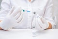 COVID-19 vaccine in researcher hands, female doctor holds syringe and bottle with vaccine for coronavirus cure. Concept of corona Royalty Free Stock Photo