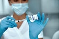 COVID-19 vaccine in researcher hands, female doctor holds syringe and bottle with vaccine for coronavirus cure. Royalty Free Stock Photo