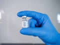 Covid-19 vaccine vial held by the gloved hand Royalty Free Stock Photo