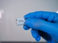Covid-19 vaccine vial held by the gloved hand Royalty Free Stock Photo