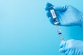 COVID-19 Vaccine vial and injection Needle Syringe against Coronavirus infection in hand of doctor with Nitrile Glove in hospital Royalty Free Stock Photo