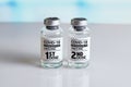 COVID-19 Vaccine Vials that require 2 injections tagged with 1st 2nd dose Royalty Free Stock Photo