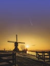 Sunrise with the Neowise comet obove Kinderdijk windmills Royalty Free Stock Photo