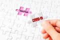 The COVID-19 word on white jigsaw puzzle go to replace elderly people word on purple gap - idea answer concept