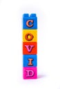 covid words are arranged in a rustic colorful lego cube. Suitable for children. Isolated on white background