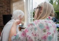 Elderly woman has hair cut by her carer during Corona virus lockdown at home Royalty Free Stock Photo