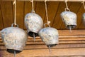 Cow-bells hanging on a wooden beam