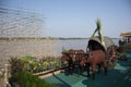 Cow cart vehicle statue at riverside of Mekong river with thai people worker build bamboo boat in the festival of Illuminated Boat