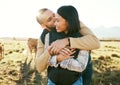 Cow farm, love and couple kiss in the countryside relax on a sustainability farm with cows. Interracial happy couple