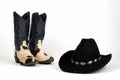 Cow Hide Cowboy Boots and Black Hat with Conchos. Royalty Free Stock Photo