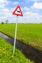 Cow warning sign in a dutch landscape Royalty Free Stock Photo