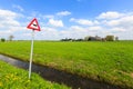 Cow warning sign in a dutch landscape Royalty Free Stock Photo