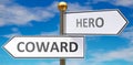 Coward and hero as different choices in life - pictured as words Coward, hero on road signs pointing at opposite ways to show that