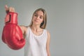 Cowardly funny young woman in red boxing gloves. Blond girl is wearing glasses Royalty Free Stock Photo