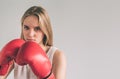 Cowardly funny young woman in red boxing gloves. Blond girl is wearing glasses Royalty Free Stock Photo