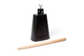 Cowbell percussion musical instrument, black metal with a wooden stick Royalty Free Stock Photo