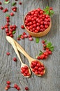 Cowberry in the wooden spoon. Cowberry in wooden bowl on rustic