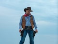 Cowboy in black suit and cowboy hat. Man with west vintage pistol revolver gun and marshal ammunition. American western Royalty Free Stock Photo