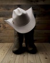 Cowboy boot and western hat on wooden background Royalty Free Stock Photo