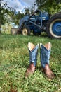 Cowboy boots and a Ford tracter Royalty Free Stock Photo