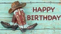 Cowboy boots and hat on a teal background Royalty Free Stock Photo